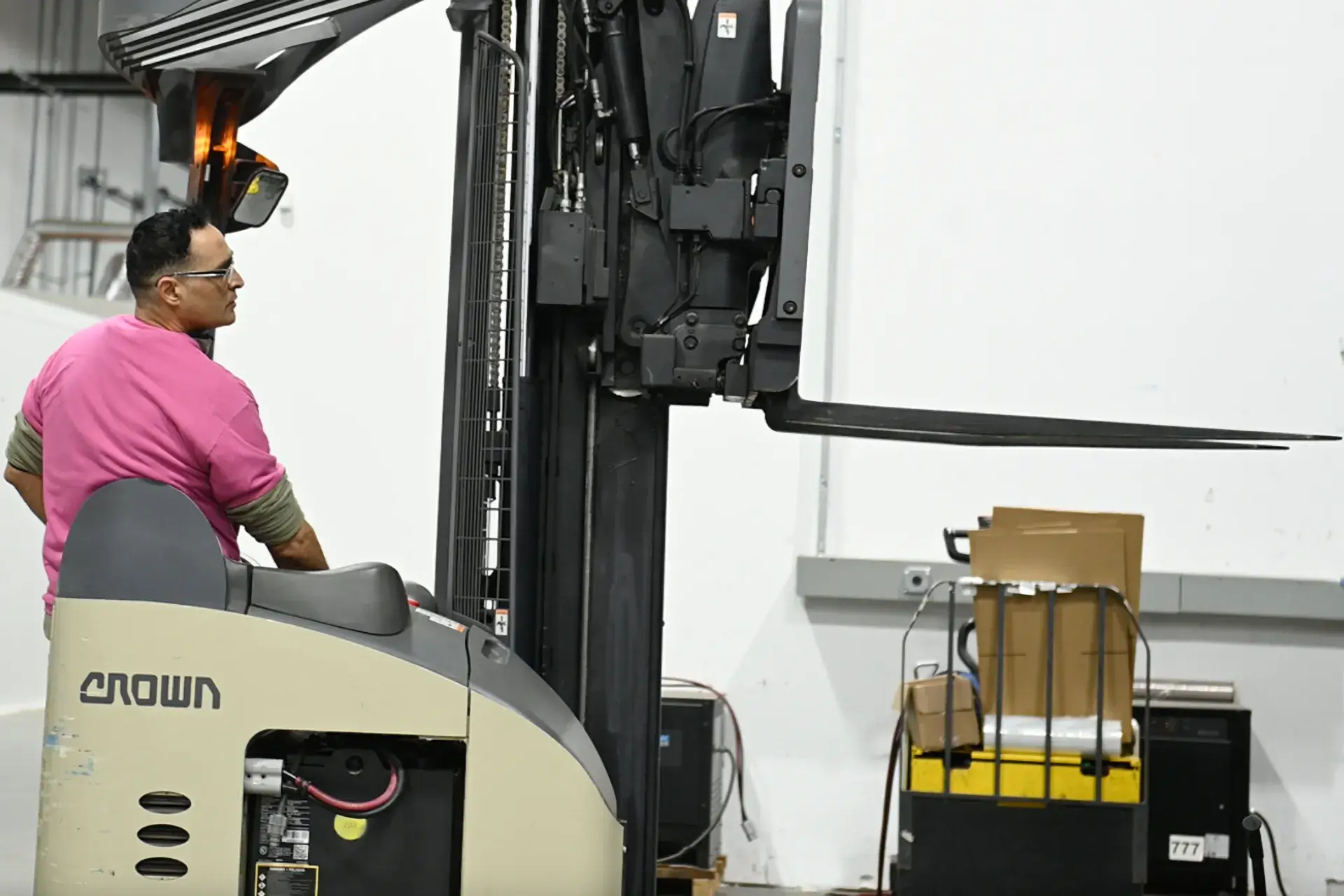 Warehouse team member driving a forklift at KOS Distribution